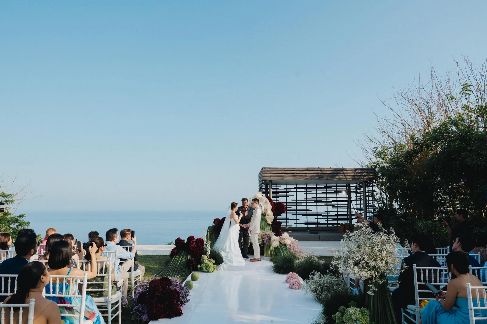 Guests seated for a ceremony on the cliff edge at Alila Villas Uluwatu