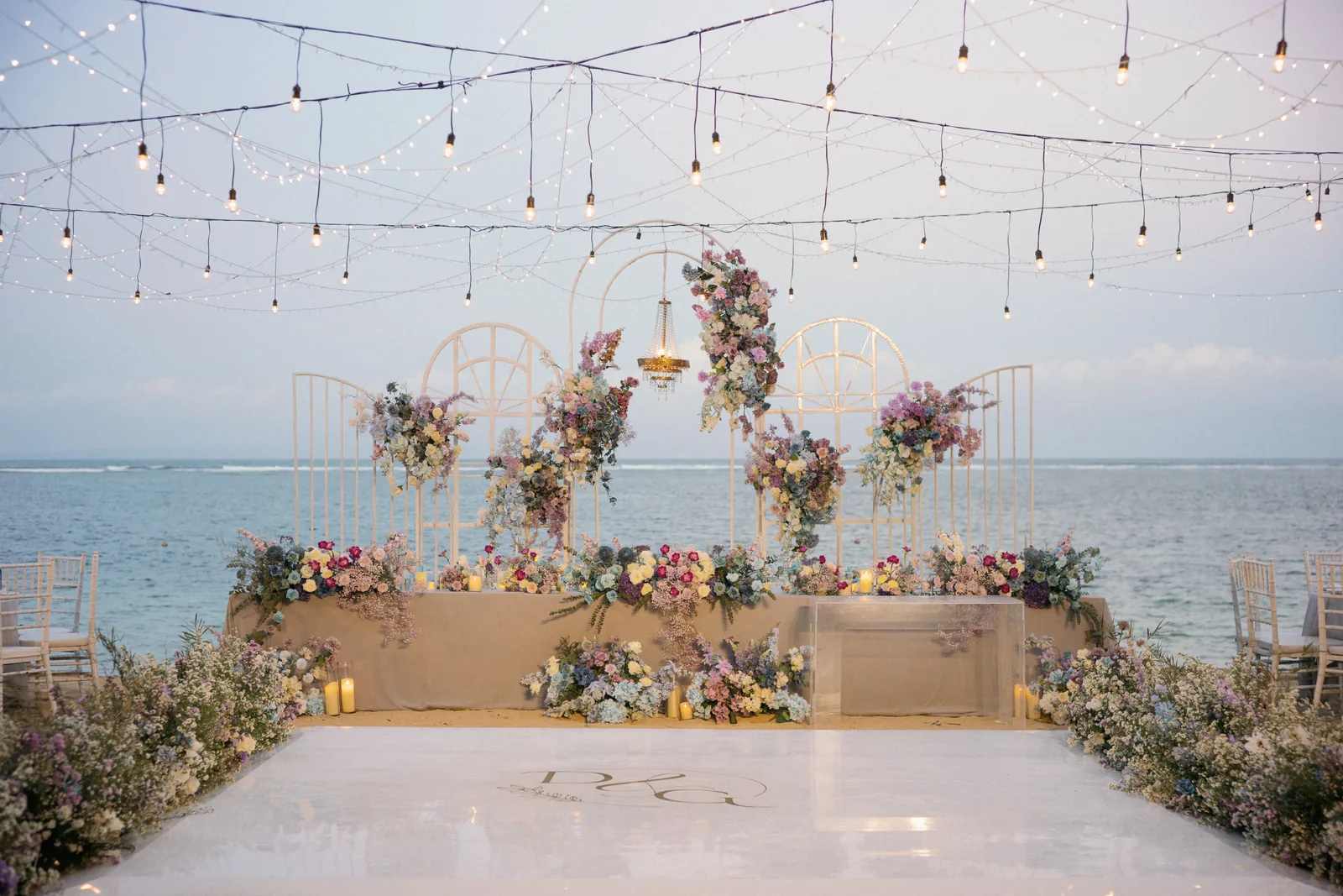 A beachfront reception at Hyatt Regency Bali under festoon lights