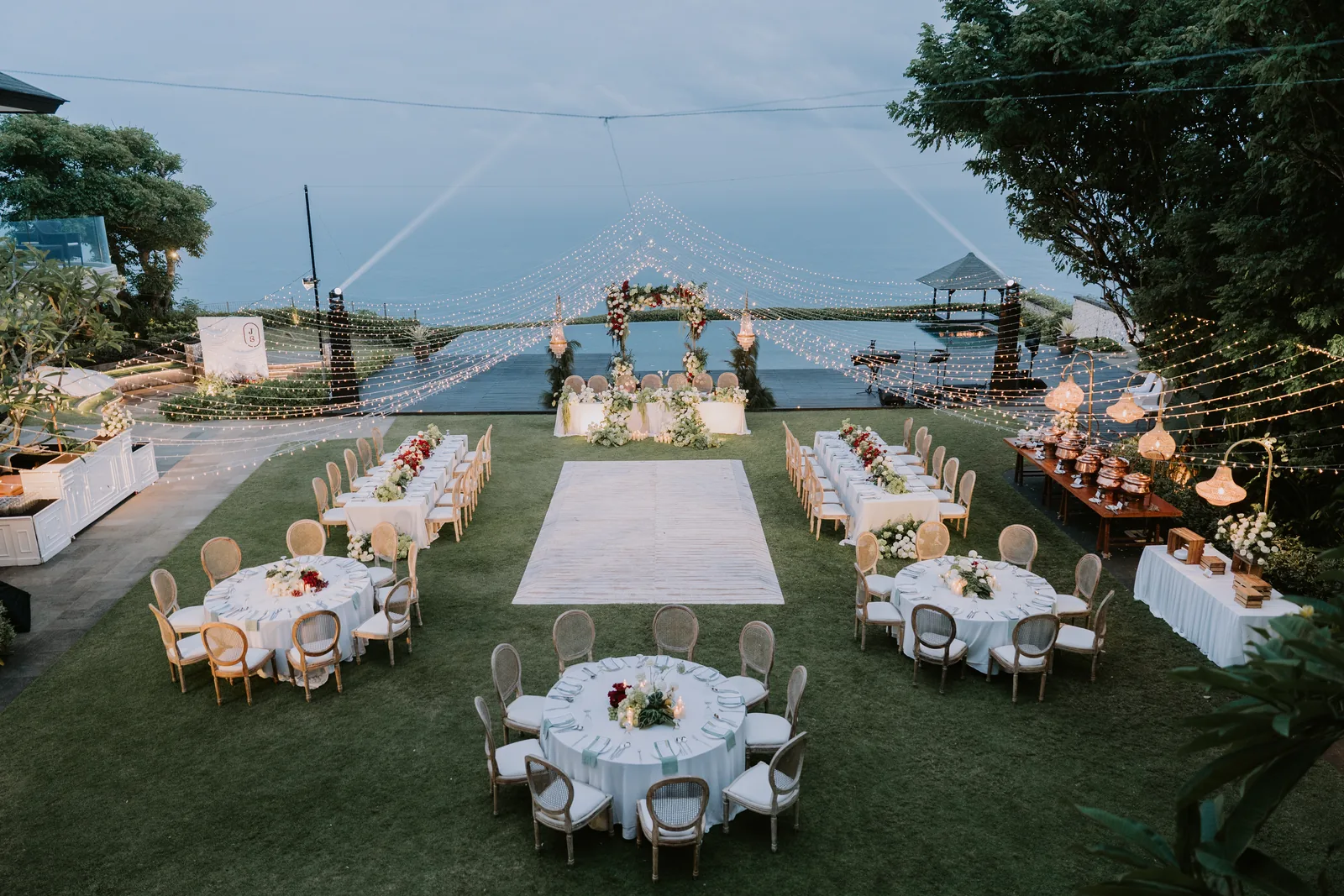 Round tables set for a reception under the marquee at Pandawa Cliff Estate